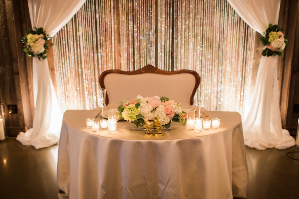 Sweetheart table with vintage settee at Kelley Farm. Planning & Flowers by Jen's Blossoms