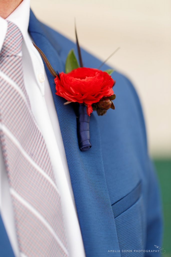 Red ranunculus boutonniere by Jen's Blossoms