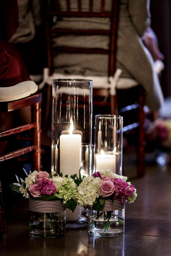 Aisle decor of candles and flowers at Kelley Farm