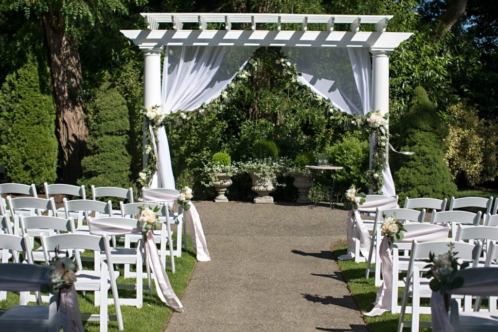 Draped arbor with garland at Laurel Creek Manor; Flowers by Jen's Blossoms