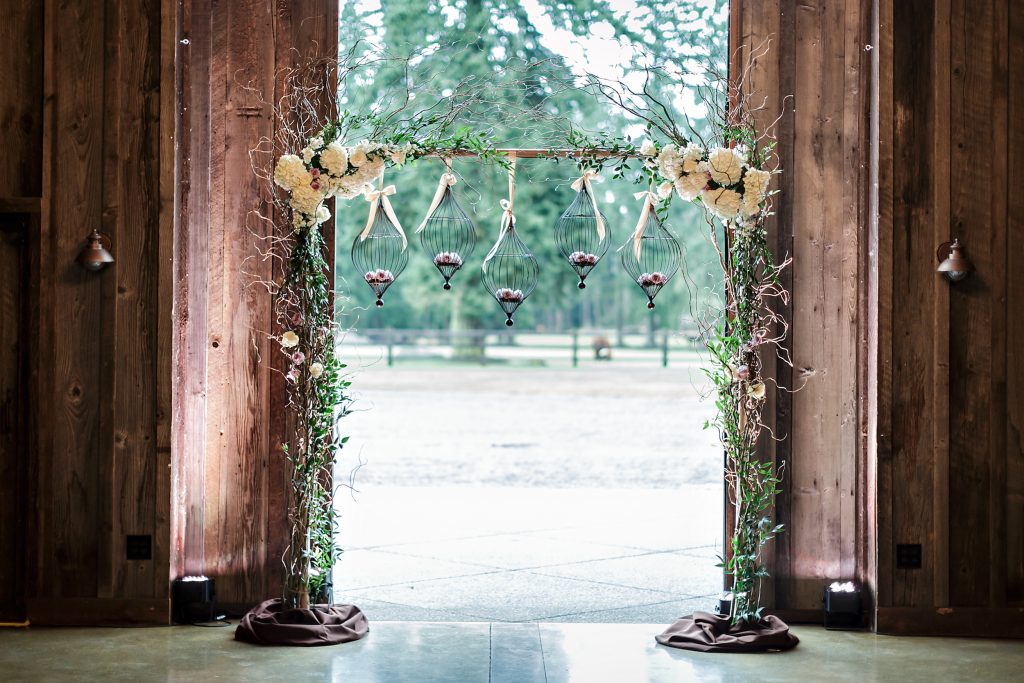 Willow arch with hanging bird cages at Kelley Farm.  Designed by Jen's Blossoms