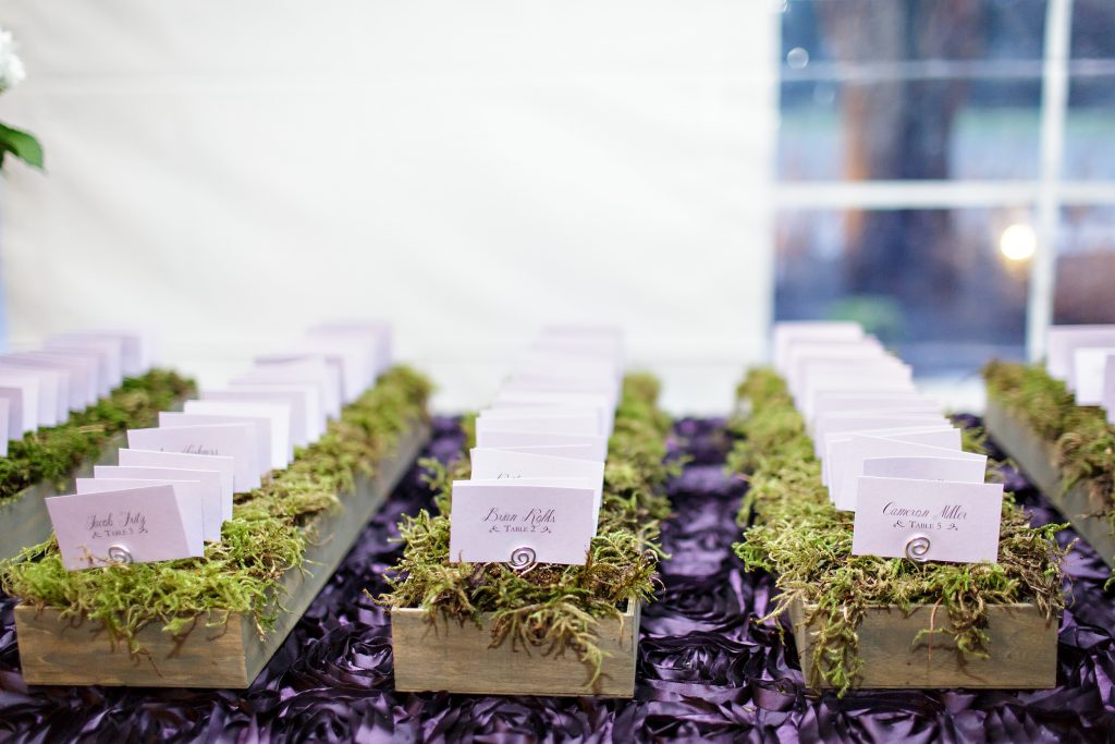 Moss lined boxes hold escort cards