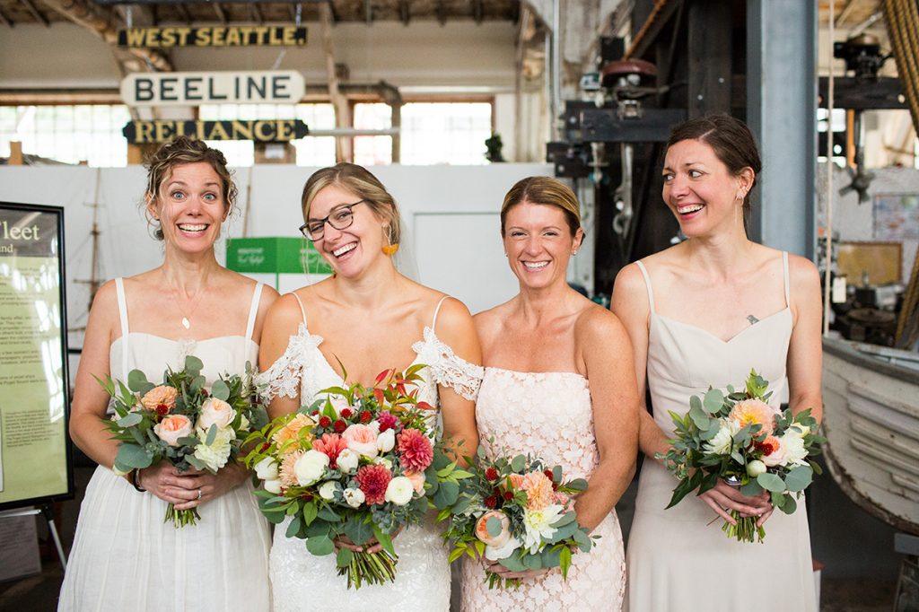 Perfectly unmatched bridesmaid dresses with bouquets of local flowers by Jen's Blossoms